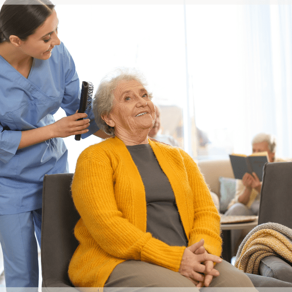 Caregiver-license-PCA-brushing-elderly-womans-hair-MeetCaregivers
